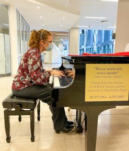 Melissa playing piano in hospital setting