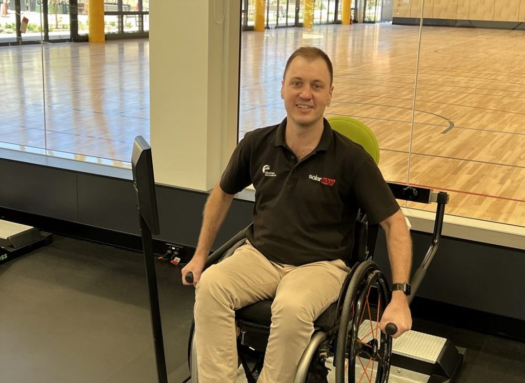 A male patient sitting in a wheelchair at the new Repat Health precinct. The gymnasium is in the background.