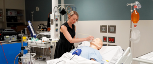 Dietitian placing post-pyloric feeding tube on training mannequin