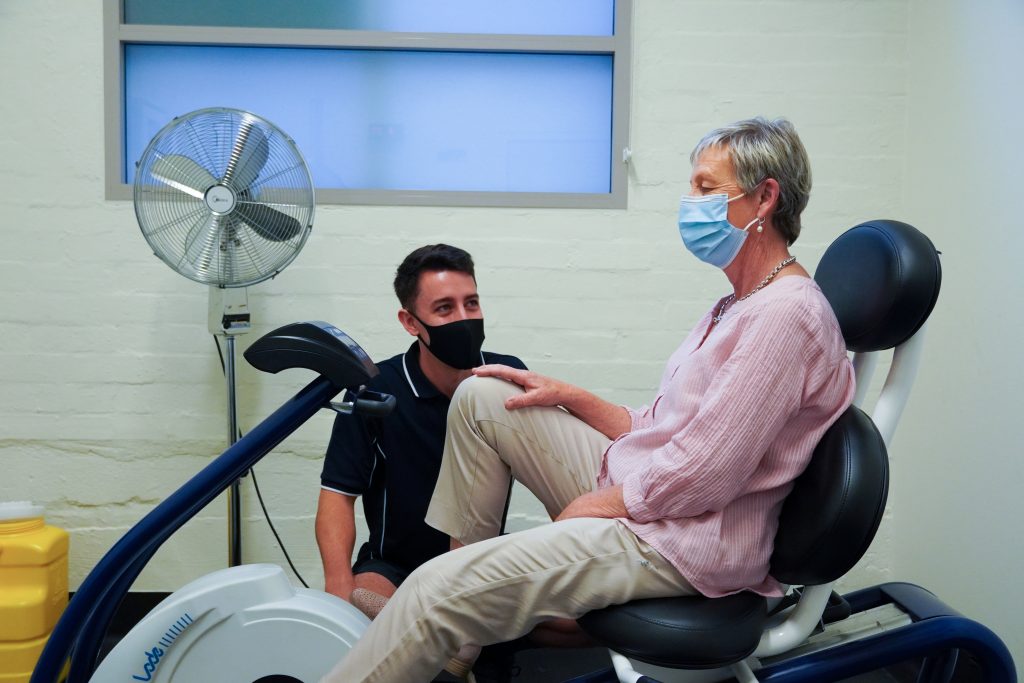Exercise Physiologist with breast cancer patient on a recumbant exercise bike