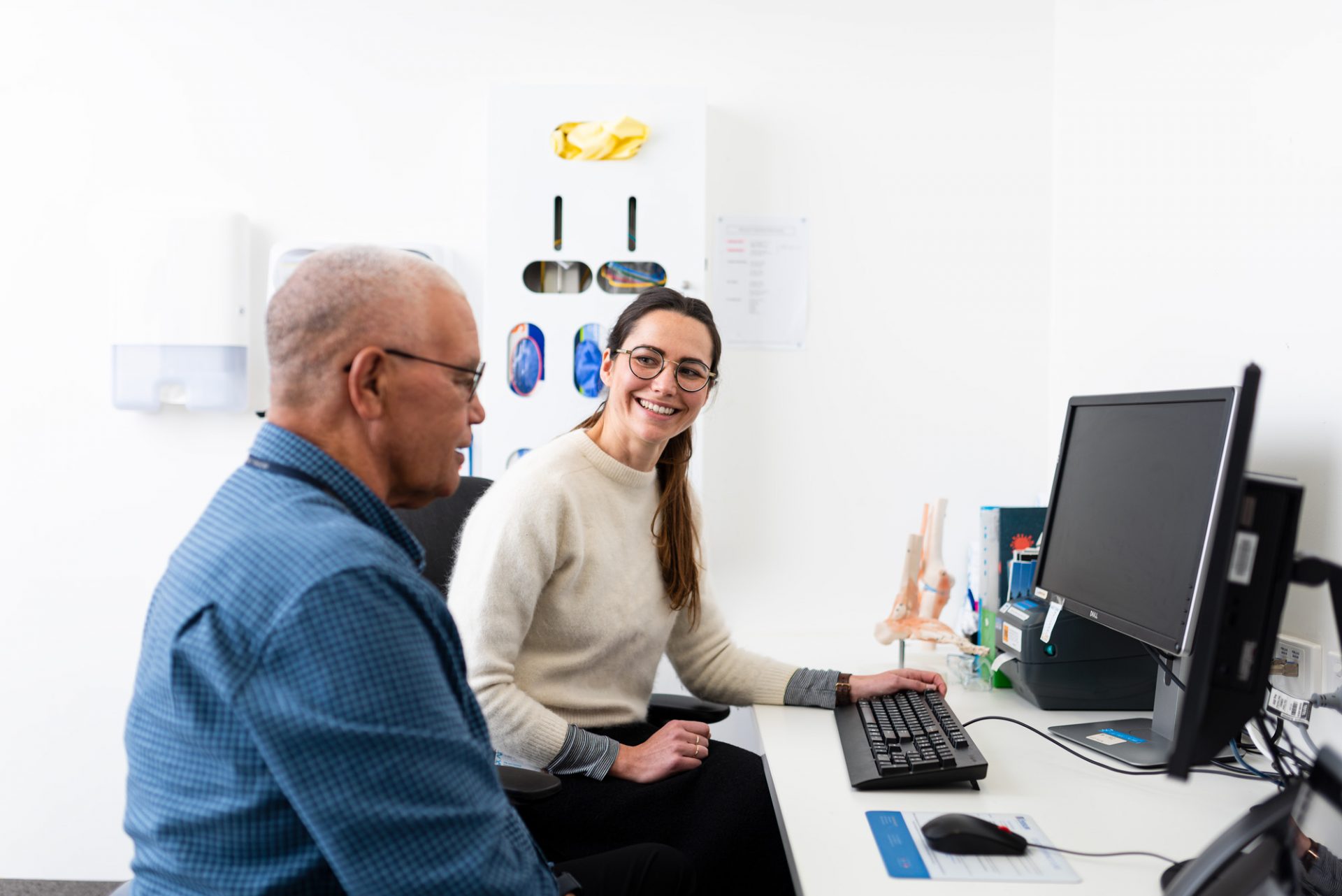 Clinician with patient in front of computer