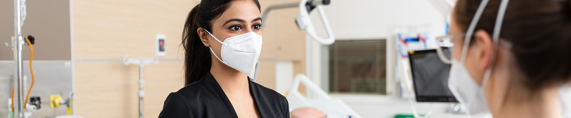 Woman in a hospital setting wearing a mask