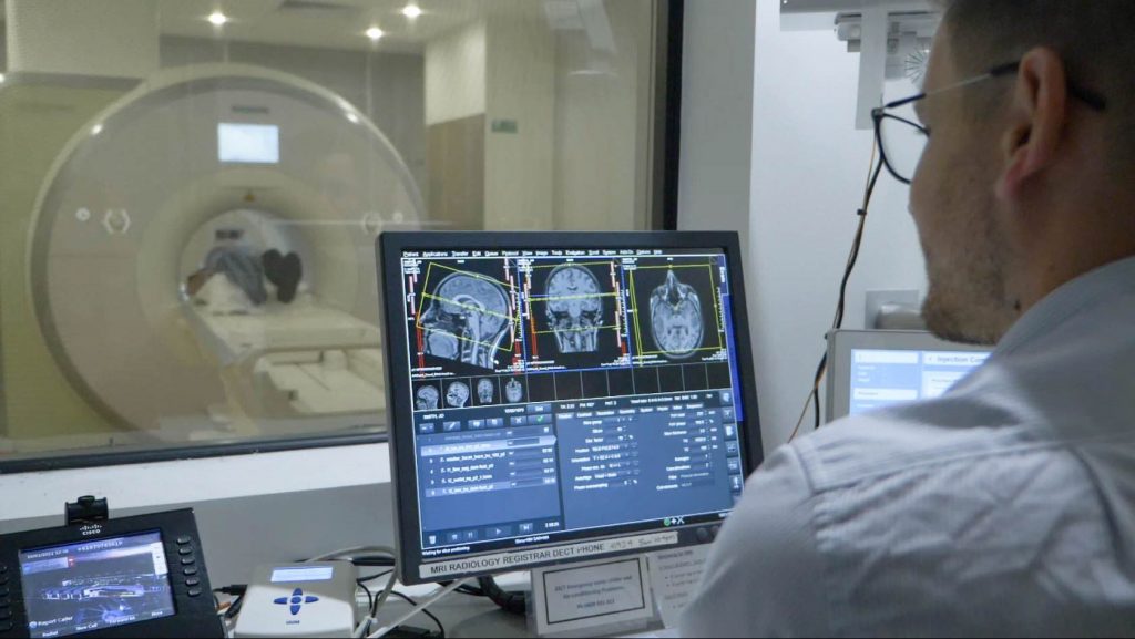 Clinician looking at monitor during MRI scan