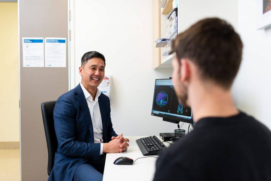 Radiation oncologist talking to patient