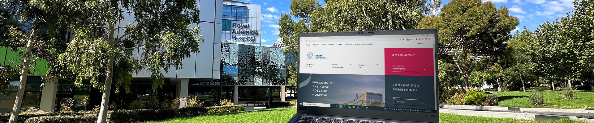 Laptop overlooking the Royal Adelaide Hospital with trees in the background.